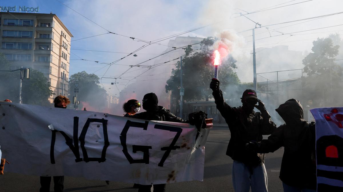 Protesters set Tesla ablaze, smash UN office’s windows in Geneva anti-G7 march